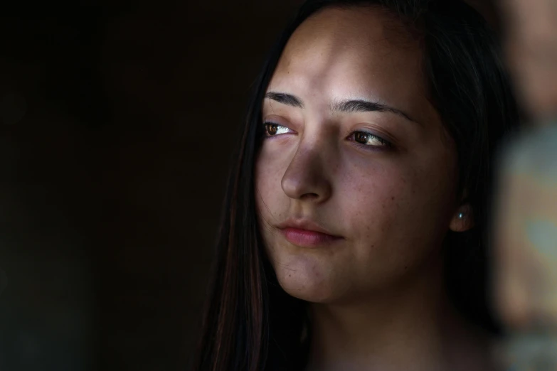 a close up of a person with a cell phone, a portrait, by Andrew Domachowski, pexels contest winner, portrait of a young pocahontas, light from right, what depression looks like, 19-year-old girl