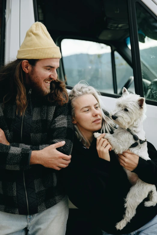 a man and woman standing next to a white dog, trending on unsplash, kombi, bedhead, a cozy, sitting