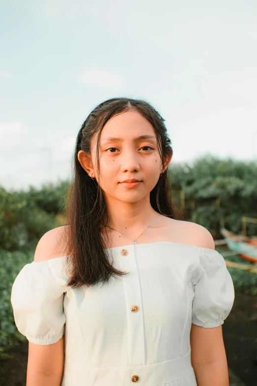 a woman in a white dress standing in a field, an album cover, inspired by Ruth Jên, pexels contest winner, young cute wan asian face, headshot, young teen, smol