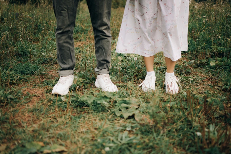 a couple standing next to each other in a field, pexels contest winner, happening, wearing white sneakers, wearing unusual clothes, feet, avatar image