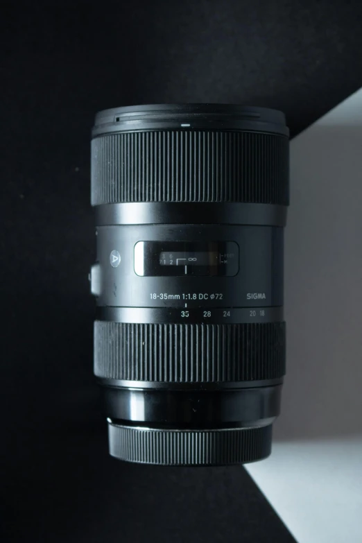 a close up of a camera lens on a table, a picture, by Robbie Trevino, unreal engine. sigma 35mm, side front view, 22 megapixels, full front view