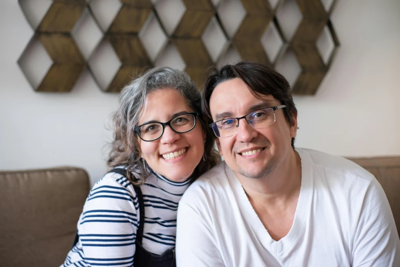 a man and a woman sitting on a couch, a portrait, by Meredith Dillman, pexels contest winner, headshot profile picture, rebecca sugar, clean design, andres rios