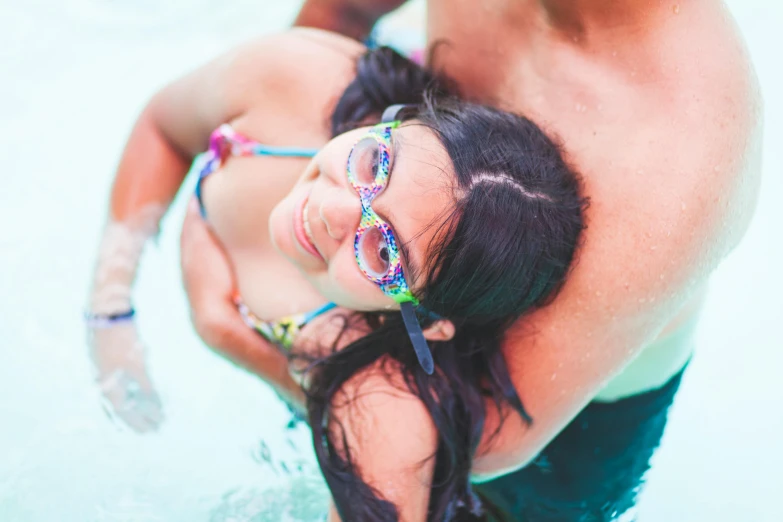 a man and a woman in a swimming pool, unsplash, wavy long black hair and glasses, wearing pearl neon bikini, closeup - view, family friendly