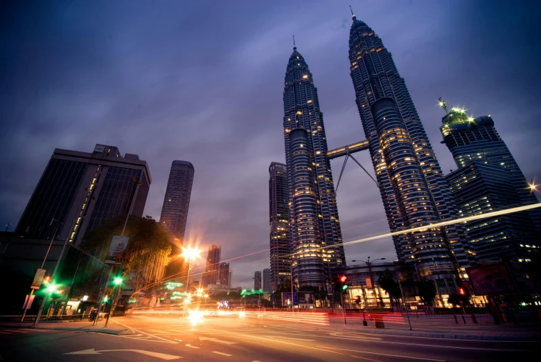 a city street filled with lots of tall buildings, by Bernardino Mei, pexels contest winner, hurufiyya, malaysian, majestic spires, bright lights, square