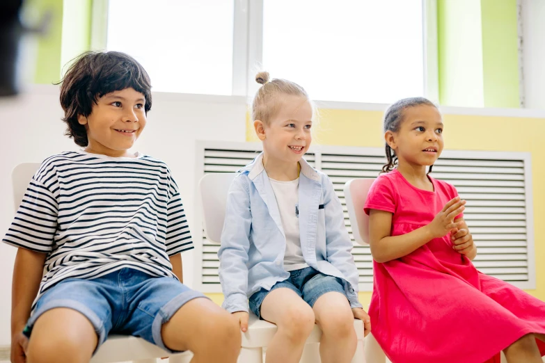 a group of young children sitting next to each other, sitting in a waiting room, profile image, school curriculum expert, fan favorite