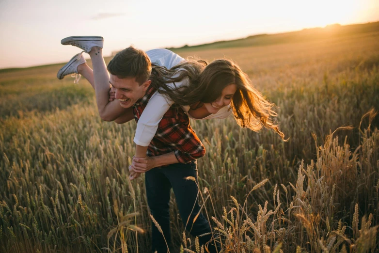 a man carrying a woman in a wheat field, pexels contest winner, playful, sydney hanson, casual game, in the evening