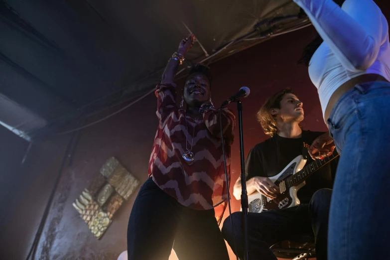 a couple of people standing on top of a stage, by Ella Guru, playing guitar onstage, charli bowater and artgeem, bottom angle, cavern