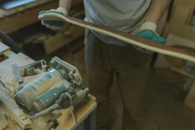 a man working on a skateboard in a workshop, trending on polycount, still from a nature documentary, toothpaste refinery, wooden trim, profile image