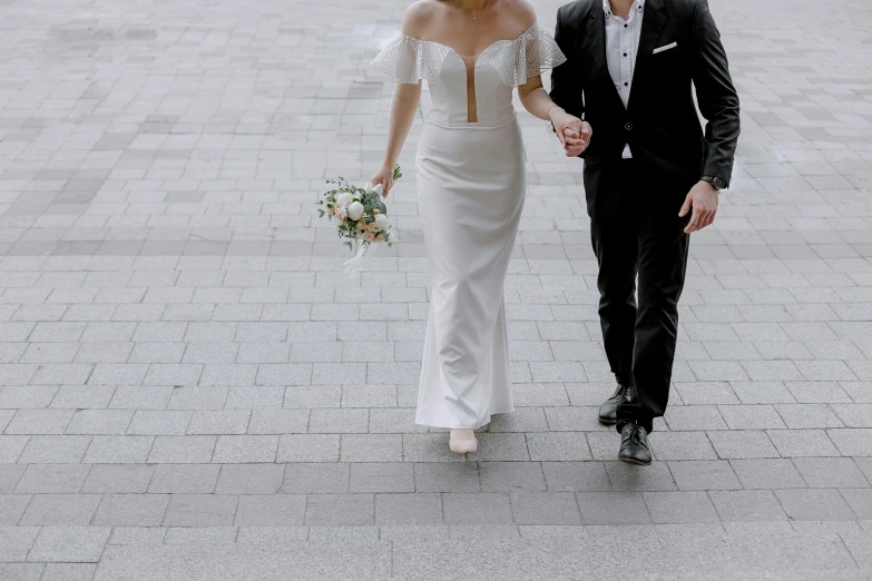 a man in a tuxedo and a woman in a wedding dress, pexels contest winner, head to toe, unedited, zoomed out view, people walking around