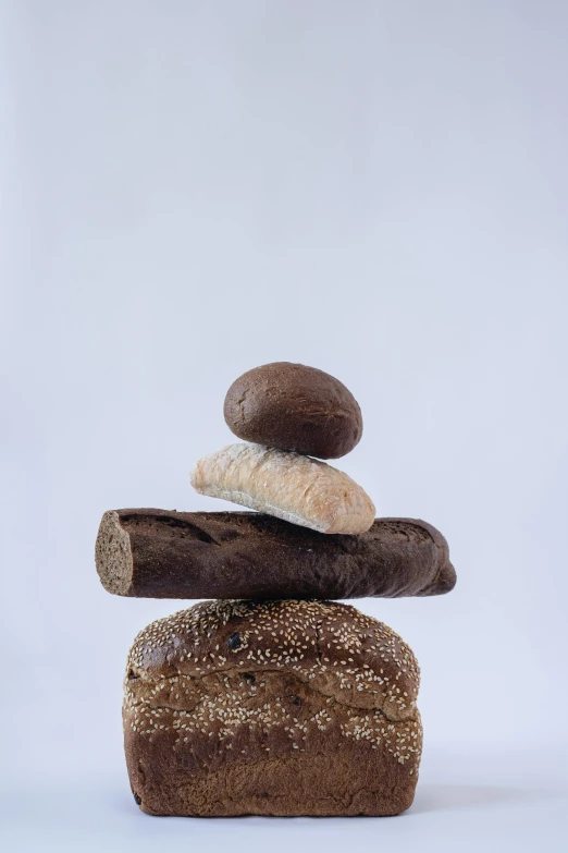 a pile of bread stacked on top of each other, by Dietmar Damerau, balance, brown:-2, mini model, high grain