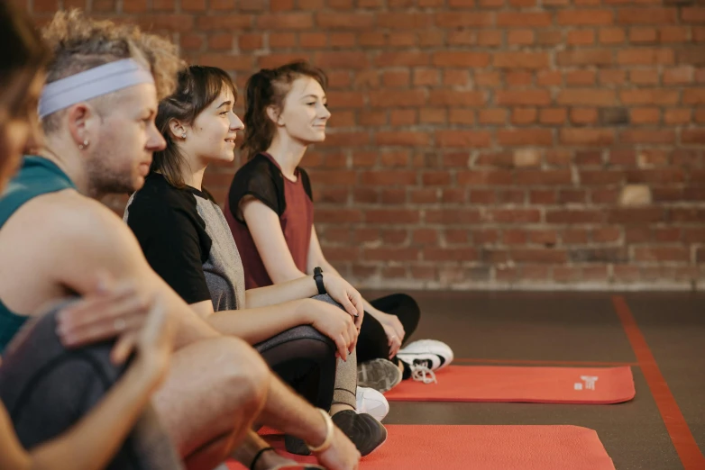 a group of people sitting on mats in a room, red sport clothing, profile image, mental health, animation