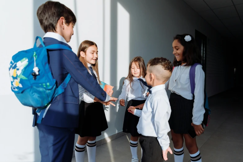 a group of young children standing next to each other, pexels contest winner, shaking hands, school uniform, profile image, looking around a corner