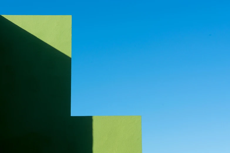 a green building with a blue sky in the background, inspired by Ricardo Bofill, postminimalism, square shapes, high shadow, one green, penrose stairs