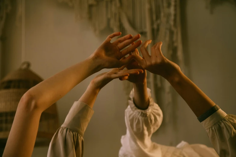 a group of people with their hands in the air, inspired by Georges de La Tour, aestheticism, cottagecore, two women, practical effects, ignant