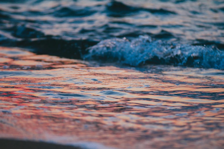 a close up of a body of water near a beach, a picture, unsplash, romanticism, evening at dusk, lsd waves, 2 0 0 0's photo, orange and blue colors