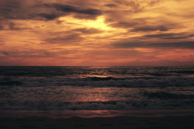 the sun is setting over the ocean on the beach, inspired by Elsa Bleda, pexels contest winner, romanticism, red stormy sky, brown, album cover, infinite