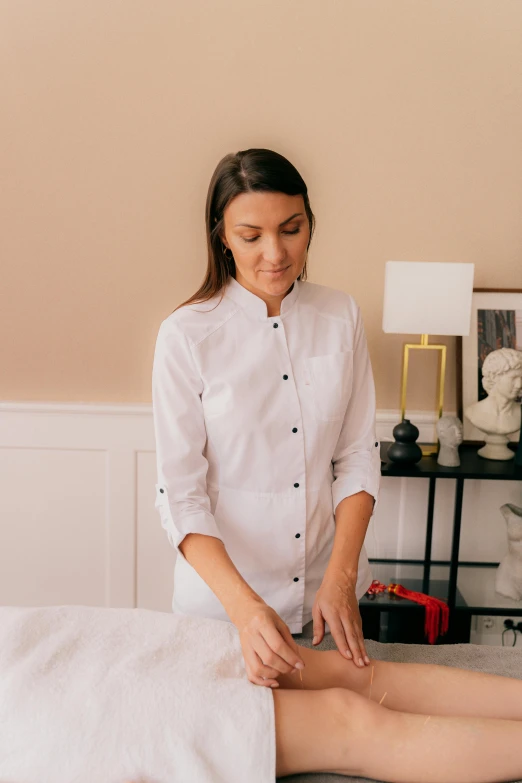 a woman getting a massage at a spa, a portrait, by Olivia Peguero, lab coat and tee shirt, low quality photo, black, medium