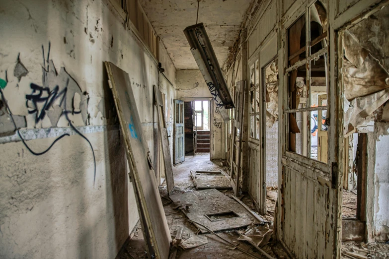 a run down building with graffiti on the walls, by Micha Klein, pexels contest winner, in school hallway, nuclear aftermath, jan urschel, an escape room in a small