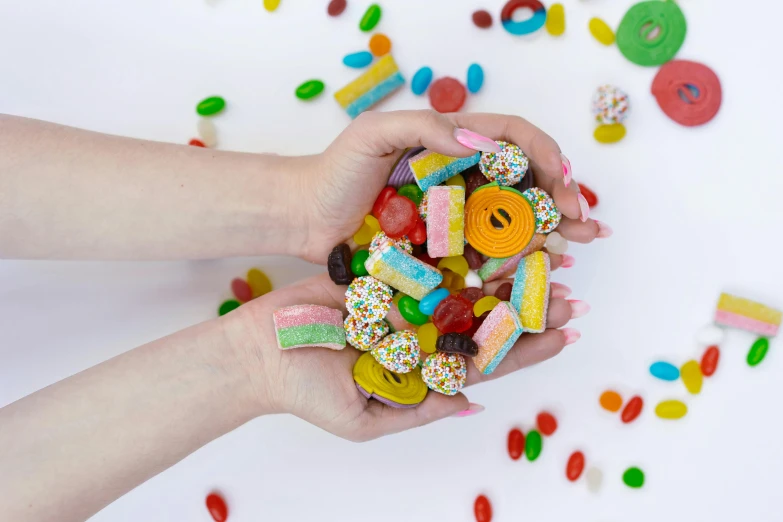 a person holding a bowl of candy and sprinkles, inspired by Damien Hirst, trending on pexels, eye level view, alphabet soup, with a bunch of stuff, sydney hanson