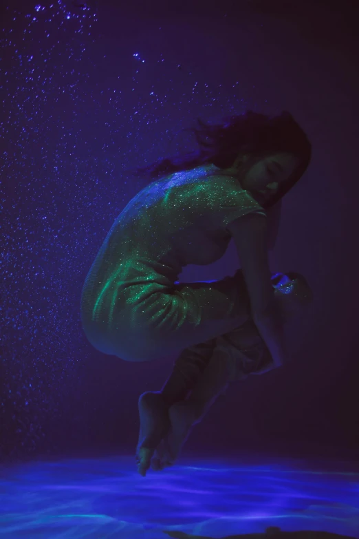 a woman that is jumping in the air, an album cover, inspired by Elsa Bleda, unsplash, holography, deep underwater, “zendaya, lying down, purple bioluminescence