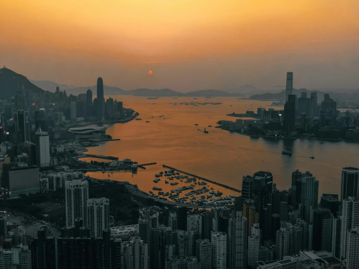 a black and white photo of a sunset over a city, pexels contest winner, city like hong kong, sunset golden hour hues, view from above on seascape, cinematic 8k