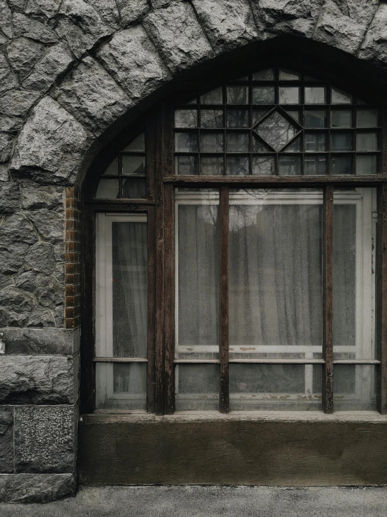 a red fire hydrant sitting in front of a window, inspired by Elsa Bleda, pexels contest winner, art nouveau, gray stone wall, gothic arch frame, marble and wood and glass, bay window