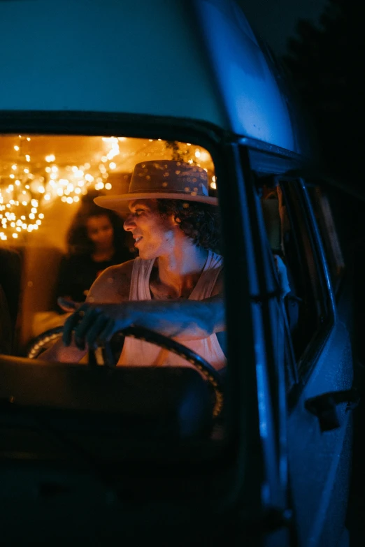 a man sitting in the driver's seat of a van at night, a portrait, by Jessie Algie, pexels contest winner, holiday season, square, in australia, justina blakeney