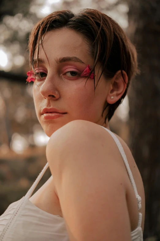 a woman with a flower in her hair, inspired by Elsa Bleda, trending on pexels, ((red)) baggy eyes, big leaf bra, androgynous person, pink forest