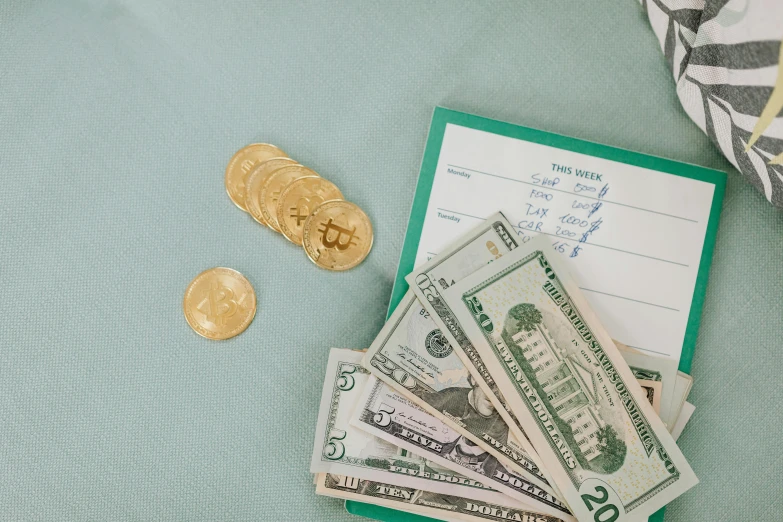 a pile of money sitting on top of a table, a photo, by Matt Cavotta, pexels contest winner, dau-al-set, cyan and gold scheme, instagram post, bitcoin, erak note