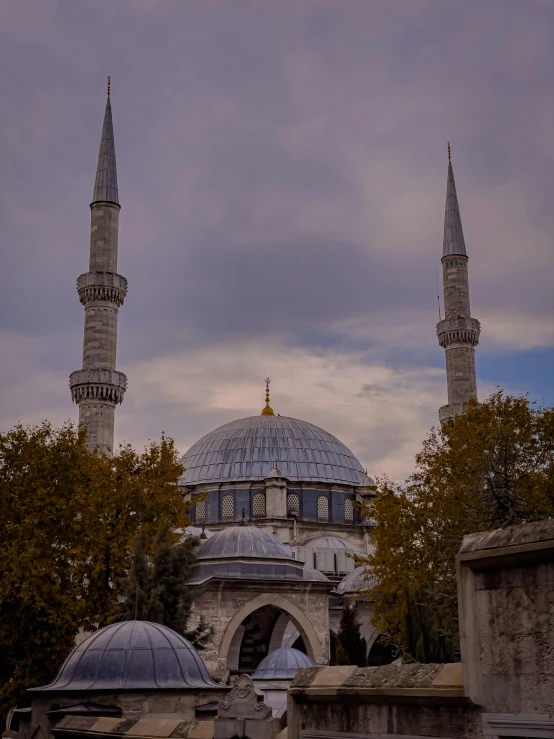 a view of a mosque in the middle of a park, a colorized photo, inspired by Altoon Sultan, pexels contest winner, hurufiyya, grey and blue theme, profile image, ☁🌪🌙👩🏾, mixture turkish and russian