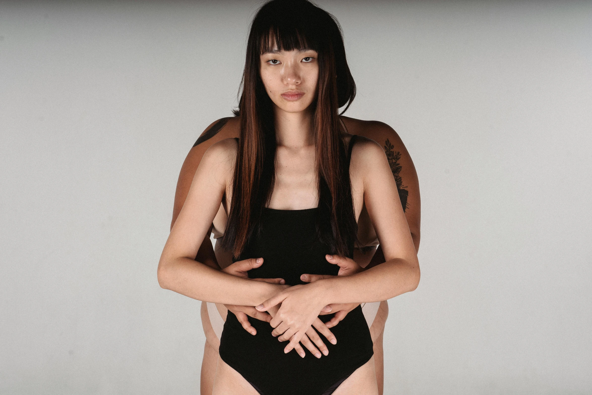 a man and a woman standing next to each other, an album cover, inspired by Wang Duo, wearing a black bodysuit, gongbi, intimately holding close, lynn skordal