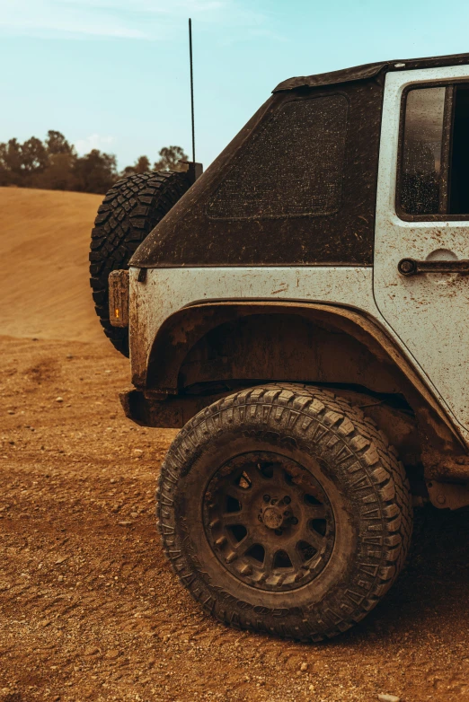 a white jeep parked on top of a dirt field, rugged details, upclose, vehicles, octane fender