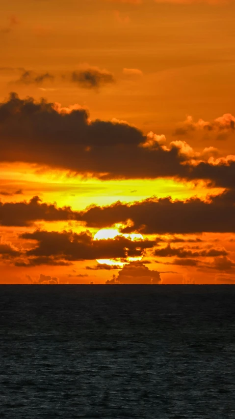 the sun is setting on the horizon of the ocean, by Robbie Trevino, pexels, yellow clouds, slide show, orange, no cropping