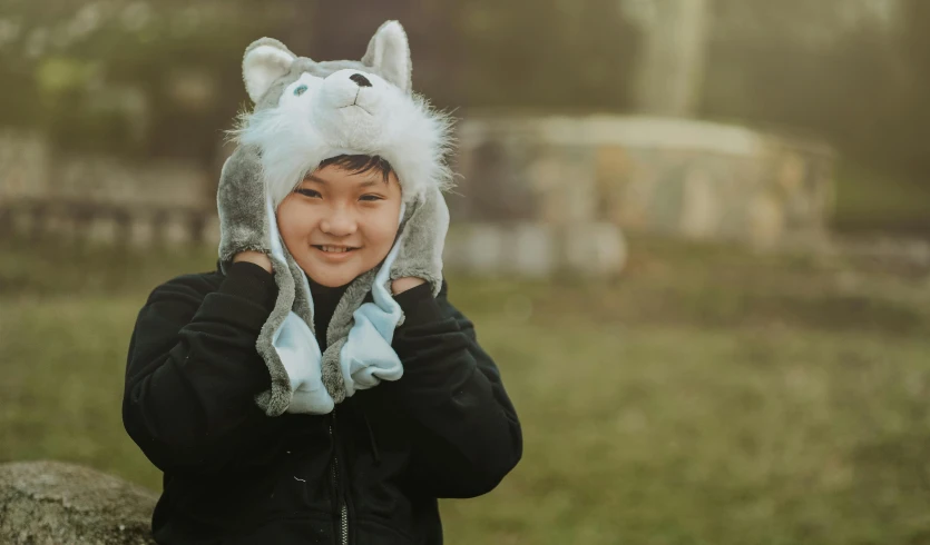 a close up of a person wearing a hat, wolf fursona, happy kid, warm features, grey