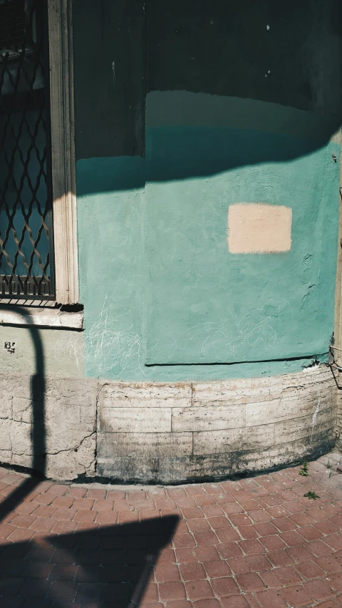 a man riding a skateboard down a sidewalk next to a building, an album cover, by Elsa Bleda, teal palette.”, cracked and faded photo paper, naples, a small