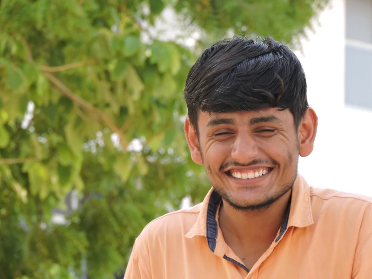 a man in an orange shirt smiles at the camera, a picture, pexels contest winner, samikshavad, profile image, around 1 9 years old, very clear image, indore