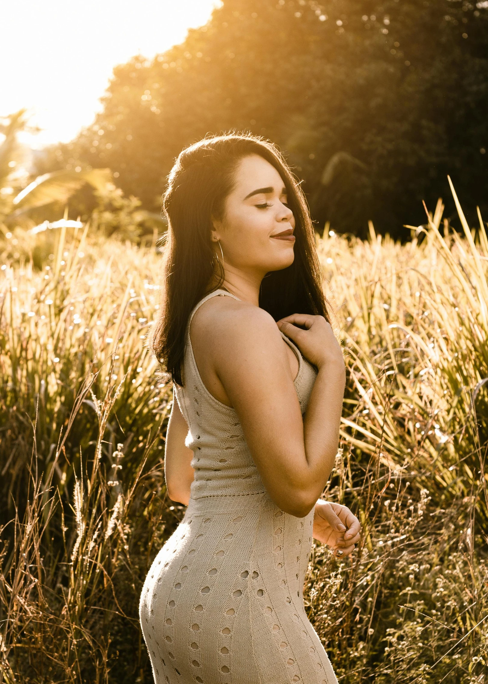 a woman standing in a field of tall grass, inspired by Elsa Bleda, pexels contest winner, happening, light skin, golden hour 8k, satisfied pose, avatar image