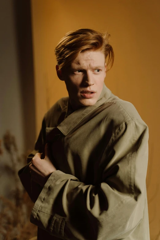 a man standing with his hands in his pockets, an album cover, ginger hair, dramatic movie still, intense albino, julian ope