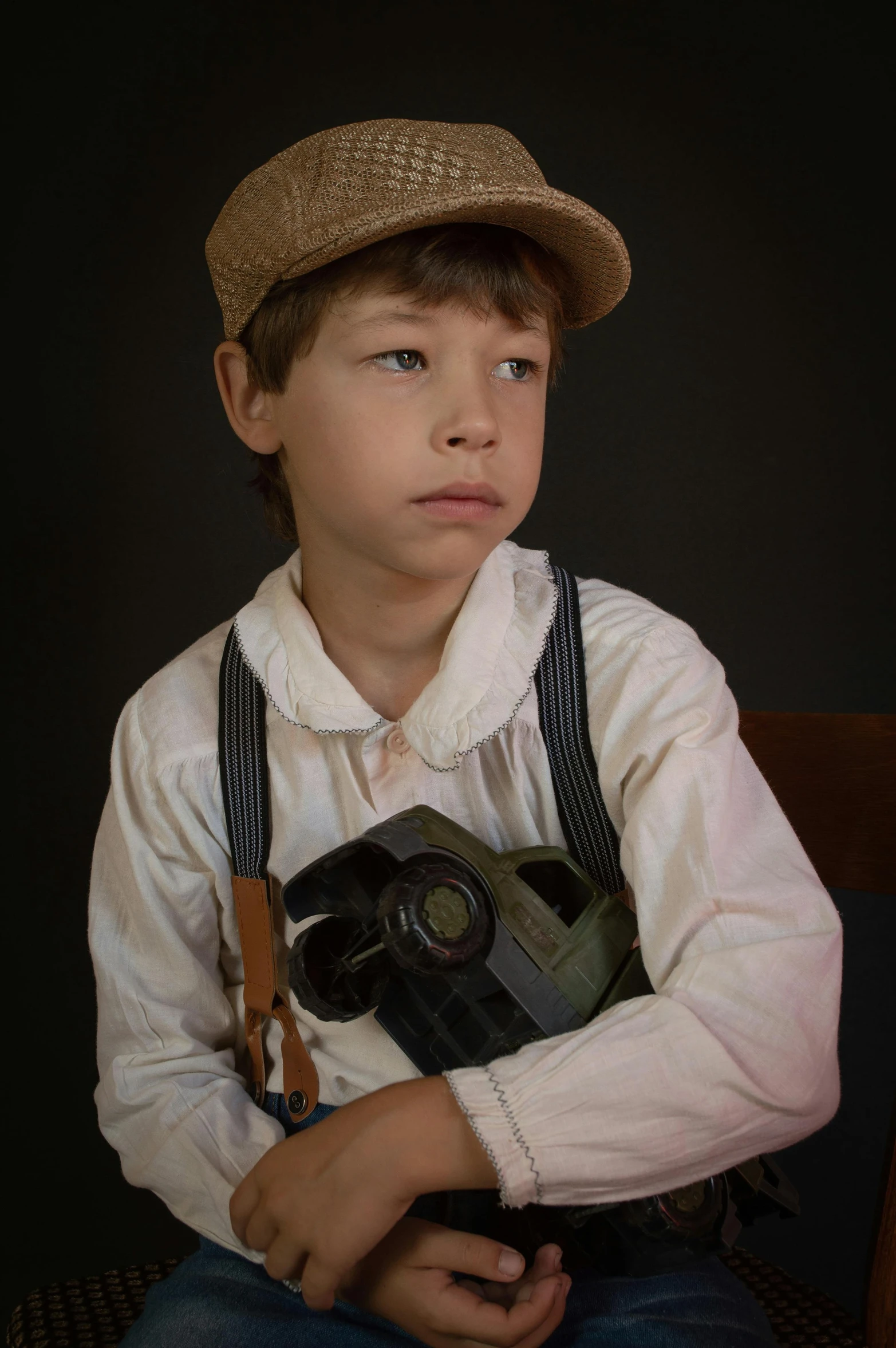 a young boy wearing a hat and holding a camera, a colorized photo, inspired by Norman Rockwell, photorealism, battle ready, cinematic bust portrait, cosplay photo, smirking deviously