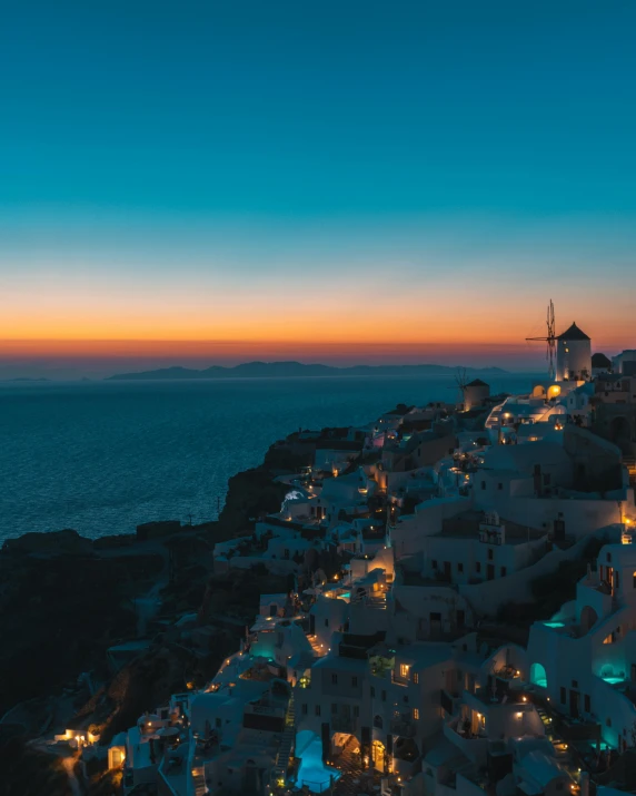 the sun sets over the village of oia on the greek island of santo, pexels contest winner, renaissance, 2019 trending photo, night lights, a photo of the ocean, background image