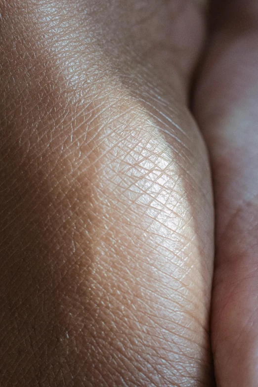 a close up of a person holding a diamond ring, by Jesse Richards, hyperrealism, natural skin tone 4k textures, palm skin, light tan, curved