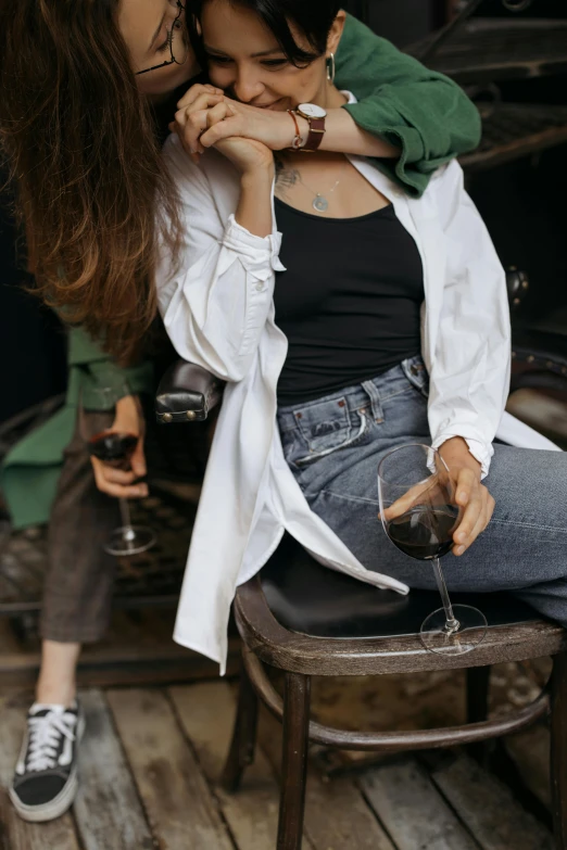 a couple of women sitting next to each other, trending on pexels, renaissance, alcohol, long shirt, middle close up composition, jacket over bare torso