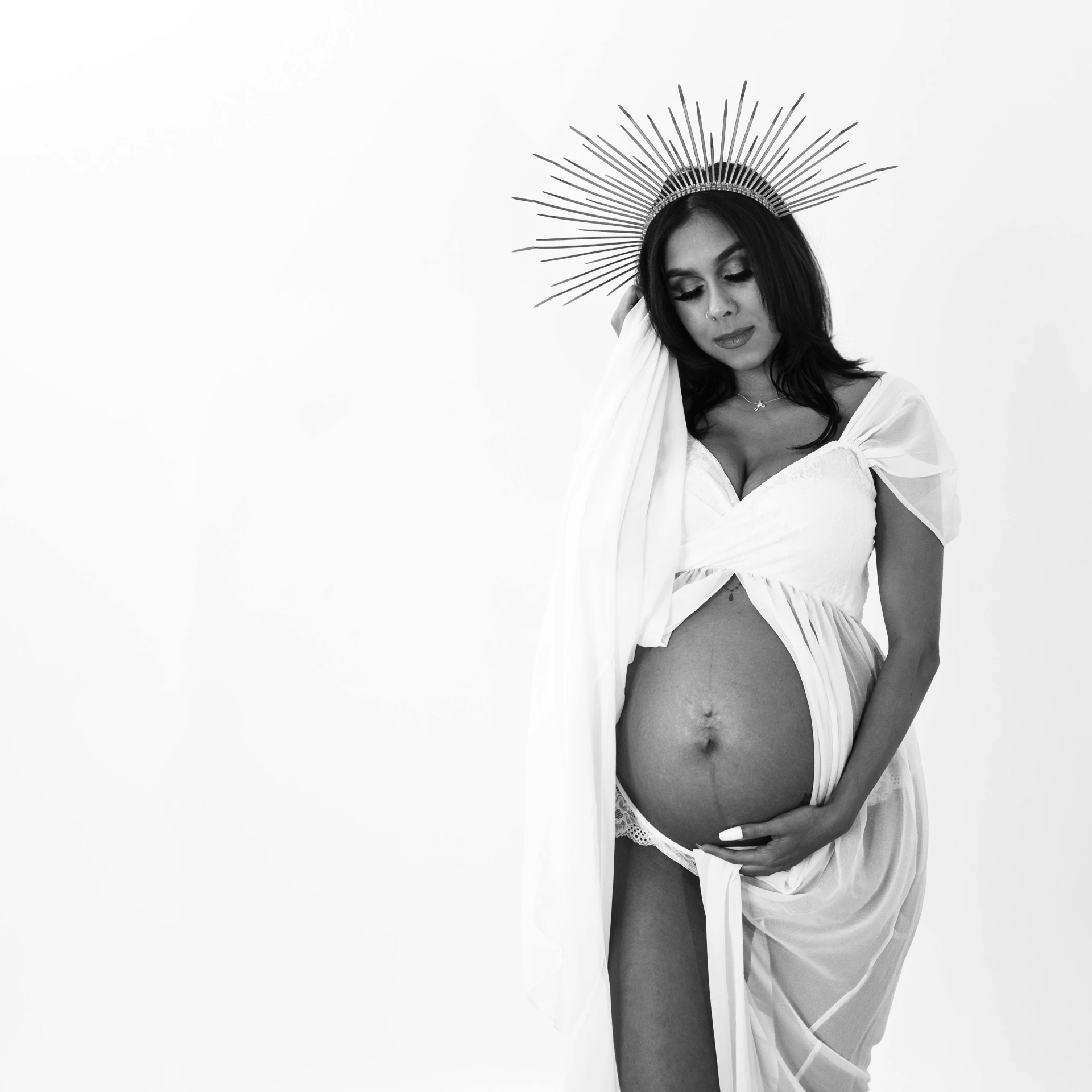 a black and white photo of a pregnant woman, a black and white photo, pexels, conceptual art, black jesus, white background : 3, crowned, white sarong