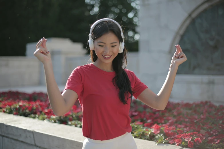 a woman in a red shirt is listening to headphones, inspired by Kim Jeong-hui, happening, wearing a light grey crown, at a park, made of carrara marble, avatar image