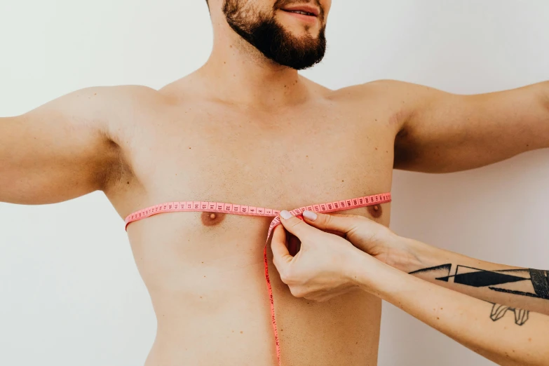 a man measuring his chest with a tape, by Nicolette Macnamara, trending on pexels, plasticien, lachlan bailey, wearing bra, ultra realistic, guide