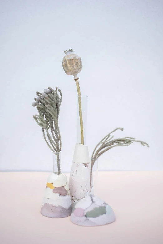 a couple of vases sitting on top of a table, a surrealist sculpture, inspired by jeonseok lee, unsplash, with frozen flowers around her, detail shot, on a botanical herbarium paper, with small object details