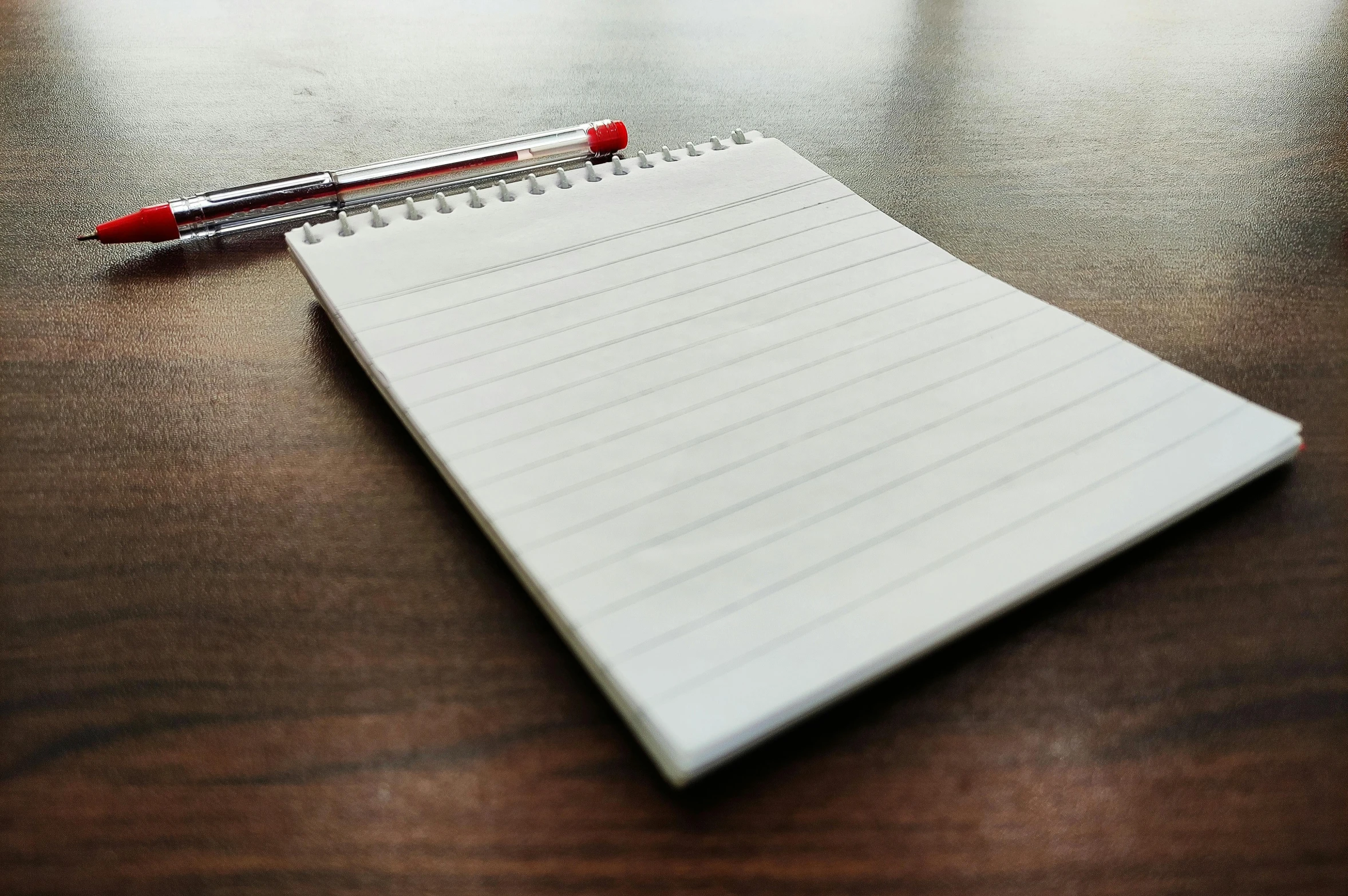 a notepad sitting on top of a wooden table, profile image, a list cast, pen, thumbnail