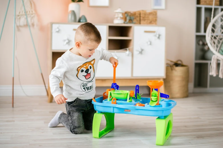 a little boy that is playing with a table, waterfals, official product photo, medium height, blippi