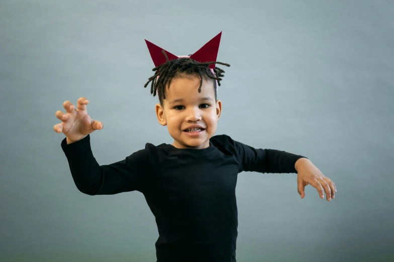 a little boy in a black shirt with a red bow on his head, pexels contest winner, conceptual art, doja cat as cat woman, two pointed ears, smiling and dancing, small in size