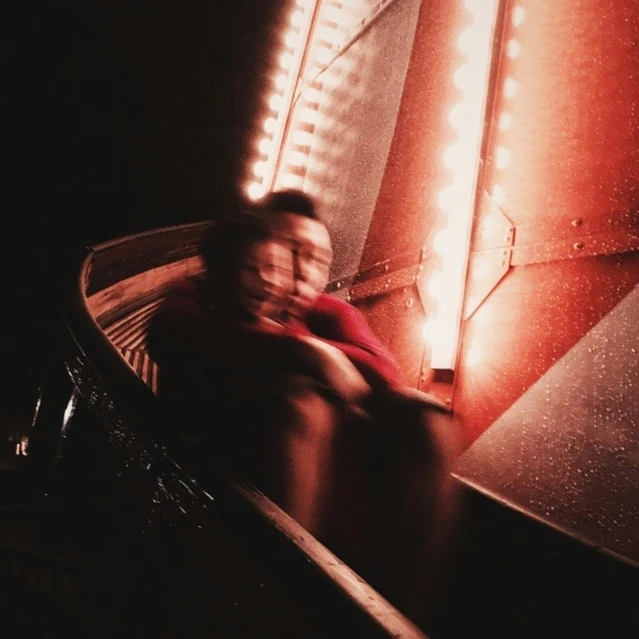 a man riding a skateboard down a ramp at night, an album cover, pexels contest winner, conceptual art, red tint, red curtain, blurred, sitting sad in spaceship